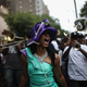 Club members and performers march during the Divine Ladies Social Aid and Pleasure Club ‘second line’ parade on May 17, 2015 in New Orleans, Louisiana. Traditional second line parades are put on by social aid and pleasure clubs organized by neighborhood in New Orleans.